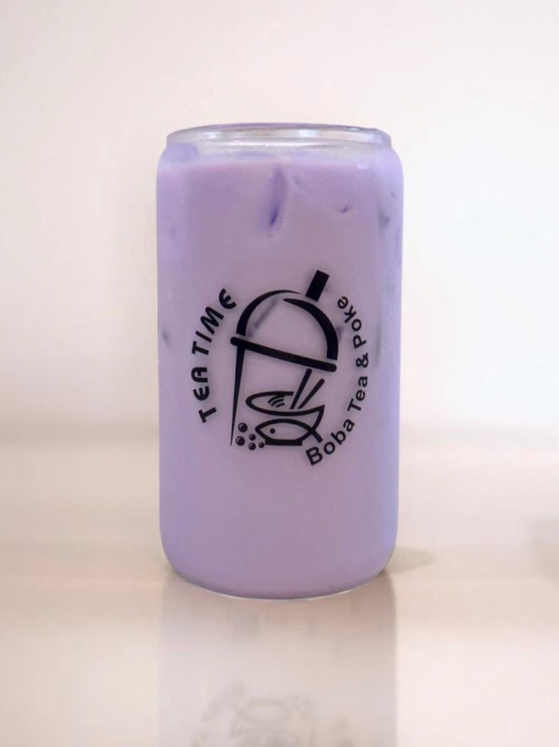 Ube taro milk tea with boba in a Tea Time glass
